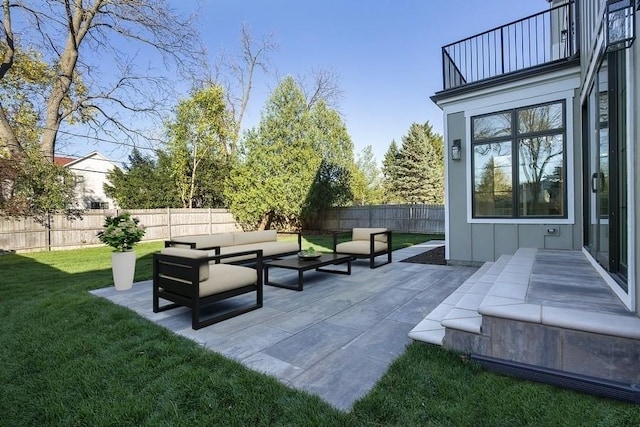 exterior space featuring a fenced backyard, a lawn, a patio, and an outdoor hangout area