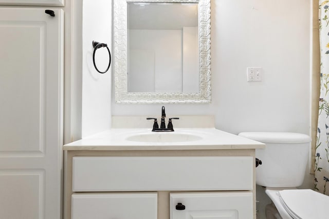 bathroom featuring toilet and vanity