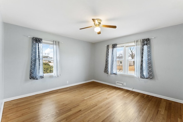 unfurnished room featuring baseboards, wood-type flooring, and ceiling fan