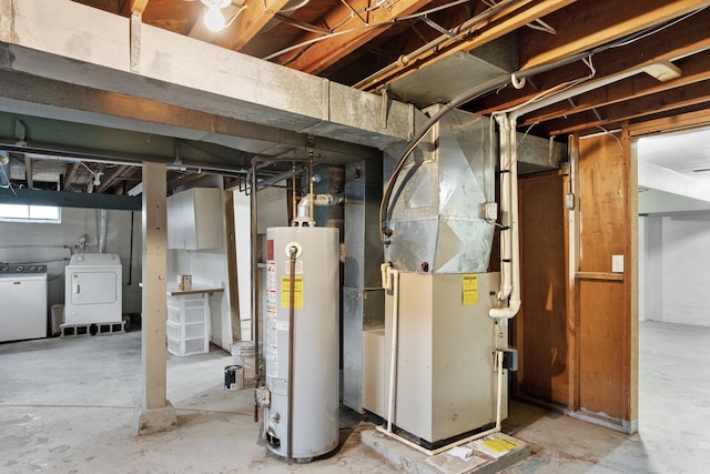 basement featuring heating unit, washing machine and dryer, and water heater