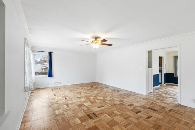 empty room with baseboards, ceiling fan, and crown molding