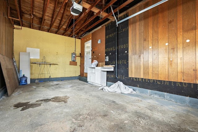 garage with electric panel and a garage door opener