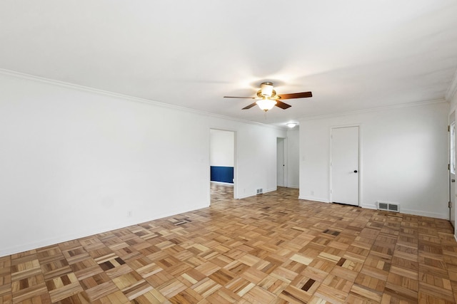 empty room with visible vents, baseboards, a ceiling fan, and ornamental molding