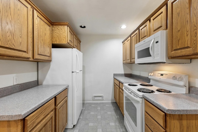 kitchen with baseboards, light floors, recessed lighting, brown cabinetry, and white appliances