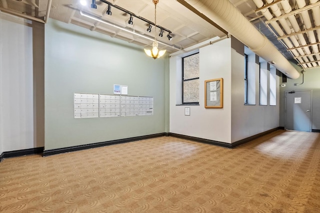 empty room with baseboards and mail area