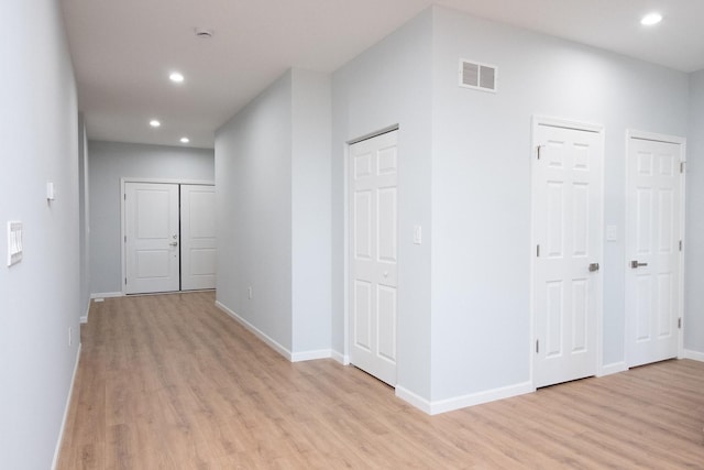 hall with recessed lighting, baseboards, visible vents, and light wood finished floors