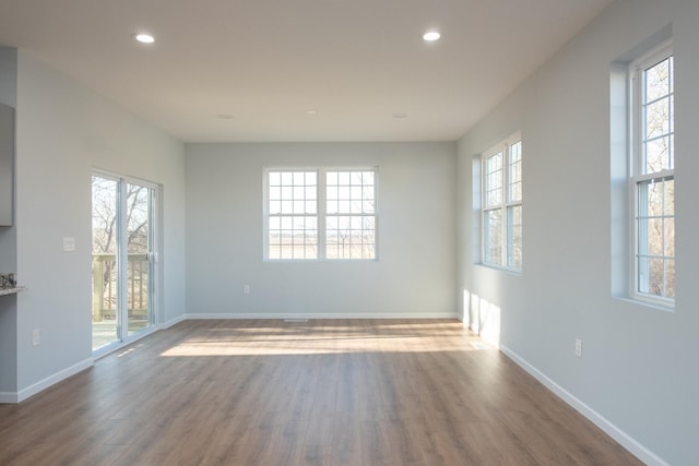 unfurnished room with recessed lighting, baseboards, and wood finished floors