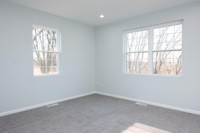 carpeted empty room with recessed lighting, visible vents, and baseboards