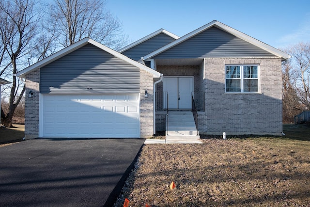 view of front of house with a garage, aphalt driveway, and brick siding