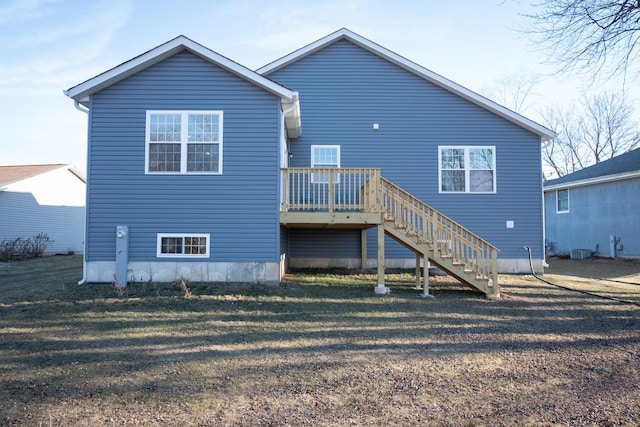 rear view of property with a wooden deck, stairs, and a yard