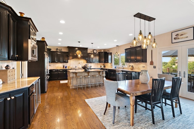 dining area with french doors, wood finished floors, and recessed lighting