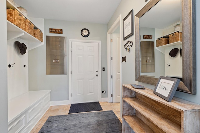 mudroom featuring light tile patterned flooring and baseboards