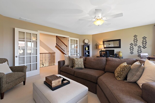 living room with a ceiling fan, light colored carpet, french doors, and visible vents