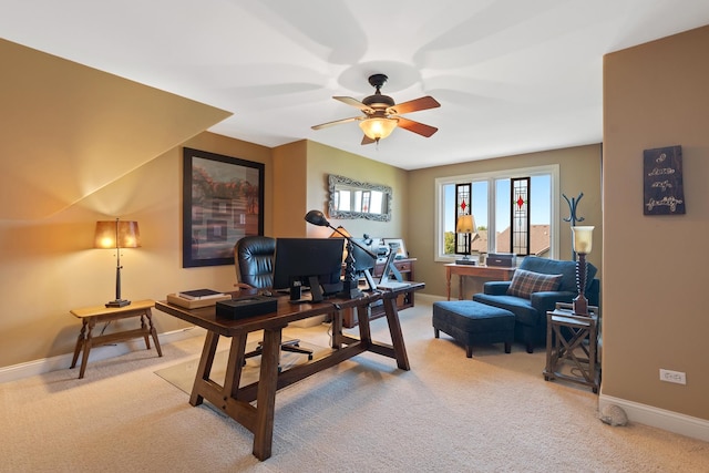 office area with ceiling fan, baseboards, and light colored carpet