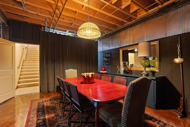 dining room with concrete floors and stairway