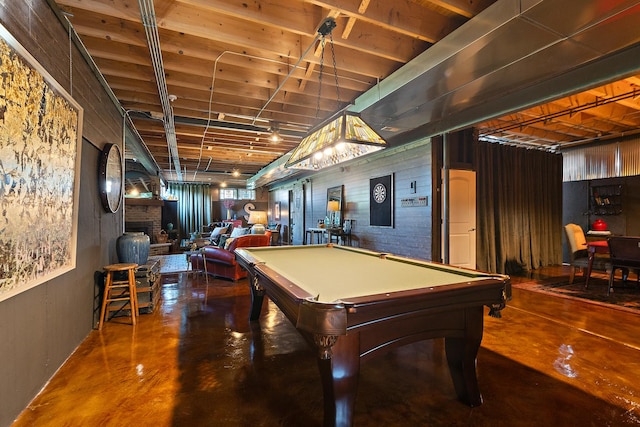 rec room with concrete flooring, pool table, and a fireplace