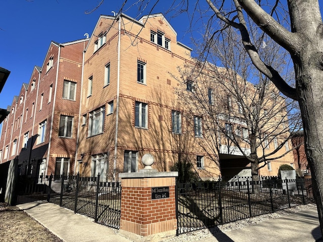 view of building exterior with a fenced front yard