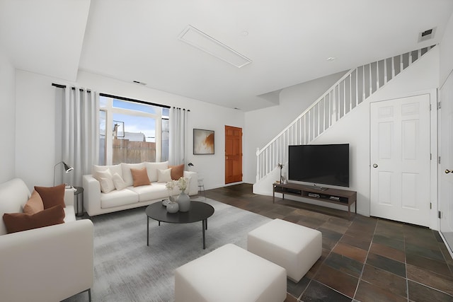 living room featuring visible vents and stairway