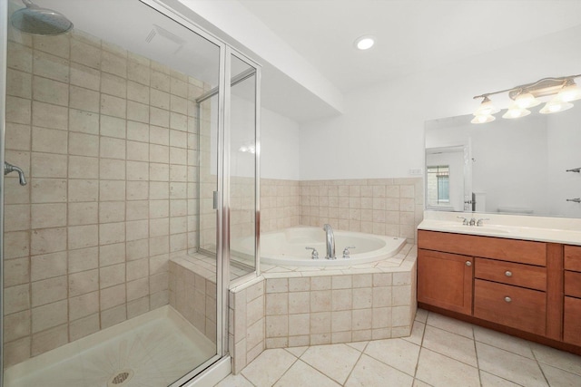 full bath with a stall shower, tile patterned flooring, a garden tub, and vanity