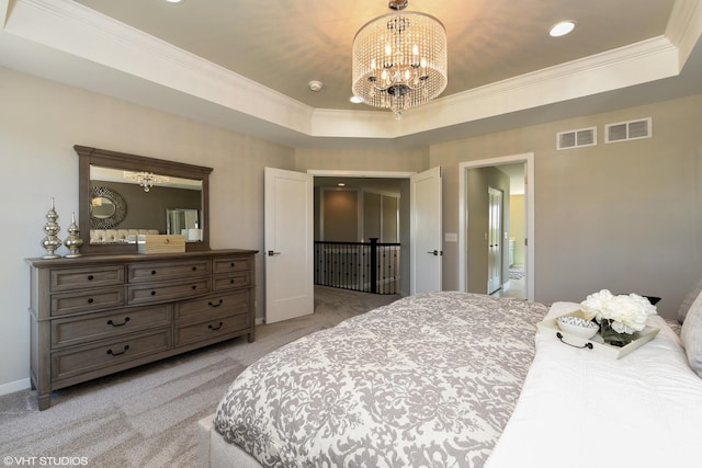 bedroom featuring a chandelier, a raised ceiling, visible vents, and ornamental molding