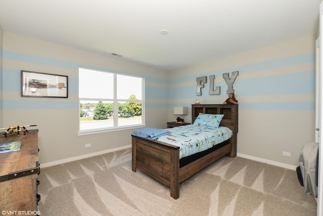 bedroom featuring carpet floors, visible vents, and baseboards