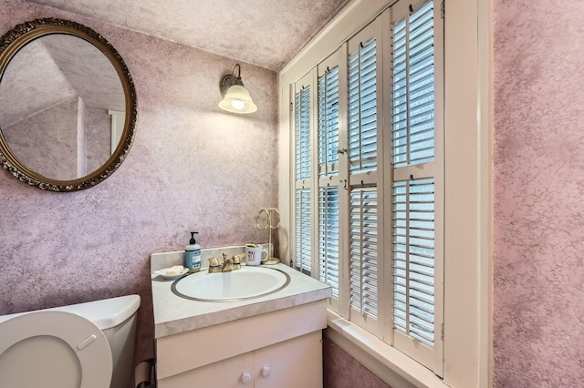 half bath featuring toilet and vanity