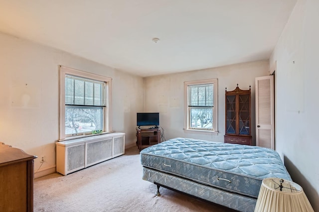 bedroom with radiator heating unit and carpet