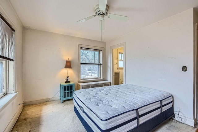 bedroom with a ceiling fan, light colored carpet, and baseboards