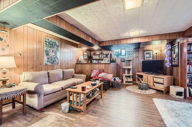 living room featuring wood-type flooring and wooden walls