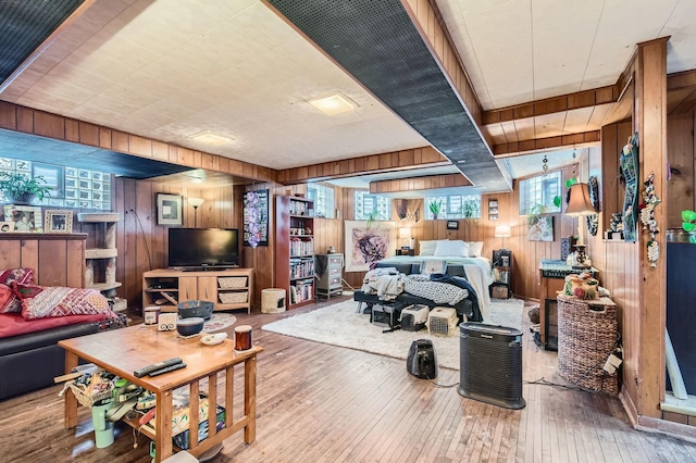 living room with wood-type flooring and wood walls