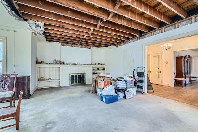 basement with carpet flooring and an inviting chandelier