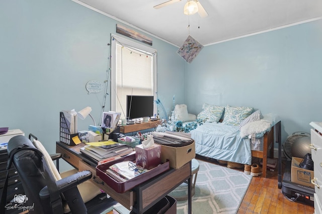 interior space with wood-type flooring, ornamental molding, and a ceiling fan