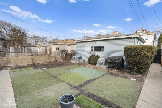 back of property featuring fence and a lawn