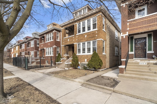 view of front of home with brick siding and fence