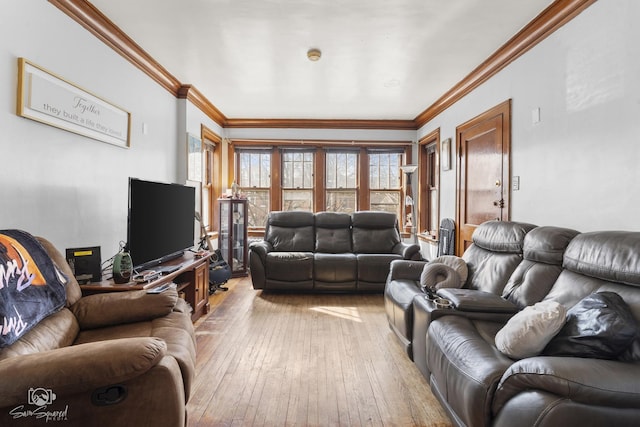 living room with light wood finished floors and crown molding