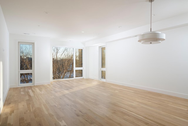 unfurnished living room featuring light wood-style floors and baseboards
