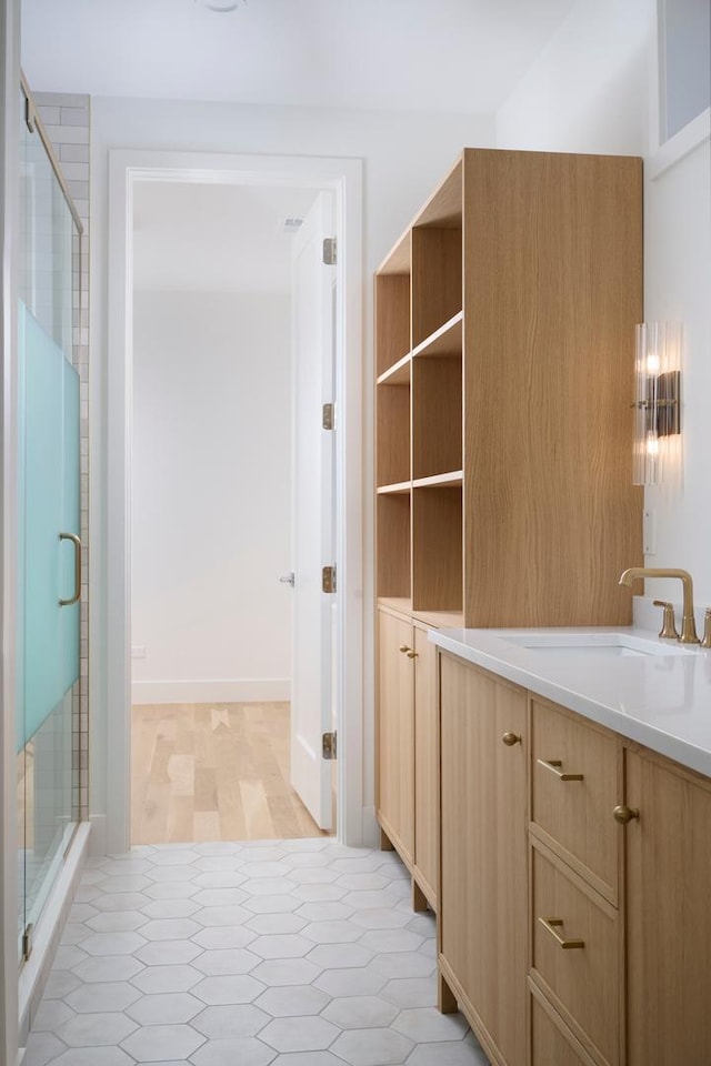 bathroom with a sink and a stall shower