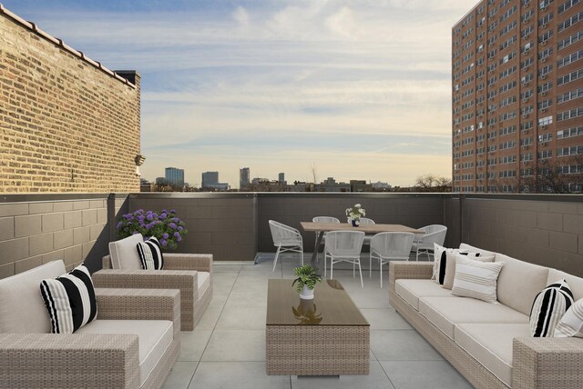 patio terrace at dusk with an outdoor hangout area, a view of city, and outdoor dining area