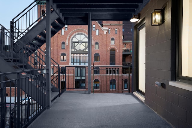 view of exterior entry featuring a balcony