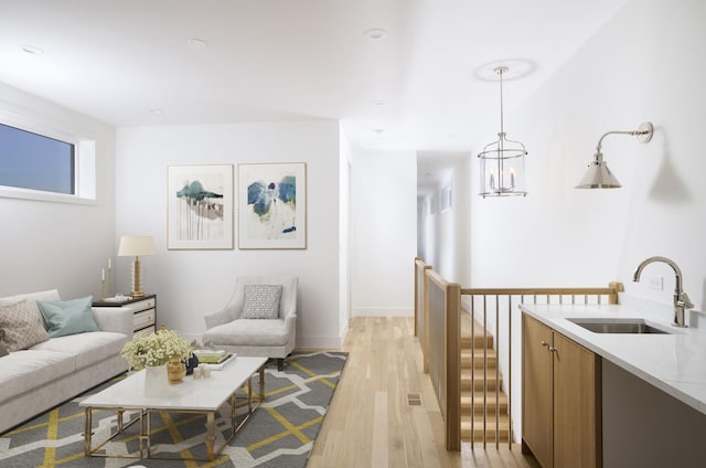 living room featuring baseboards, light wood-style flooring, and visible vents
