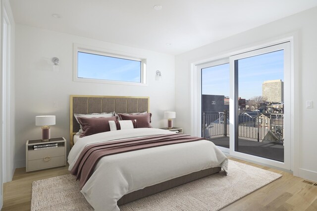 bedroom featuring light wood-style floors and access to exterior
