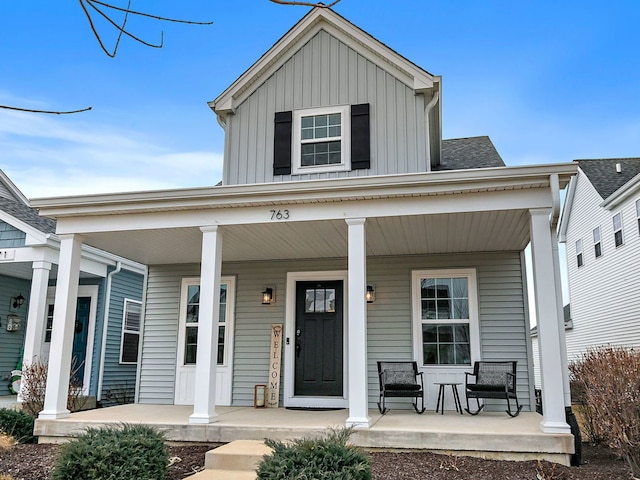 view of front of house featuring covered porch, a shingled roof, and board and batten siding