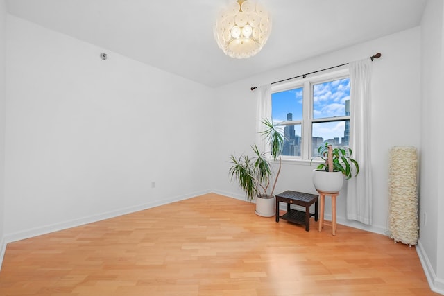 sitting room with baseboards and light wood-style floors