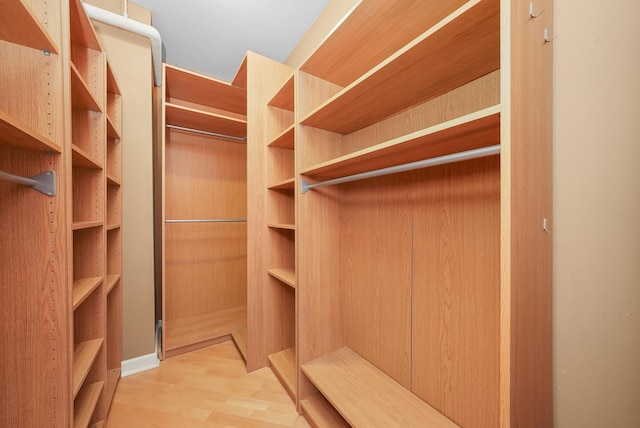 walk in closet featuring wood finished floors