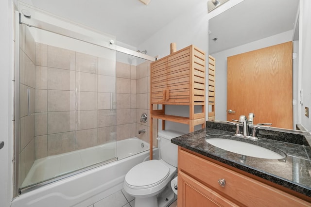 full bathroom with tile patterned flooring, combined bath / shower with glass door, vanity, and toilet