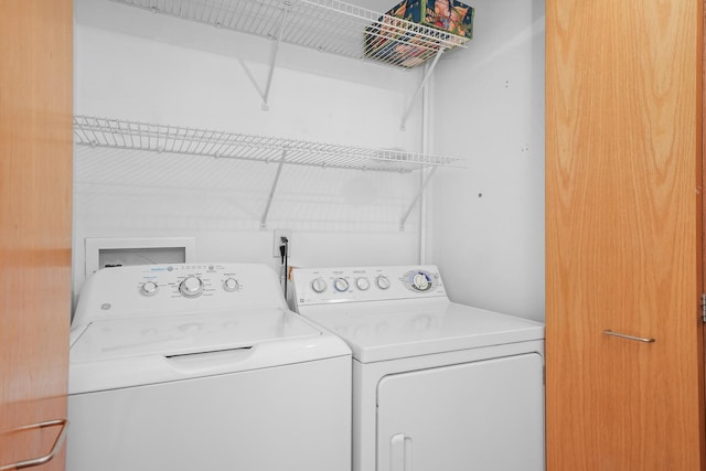 clothes washing area with laundry area and separate washer and dryer