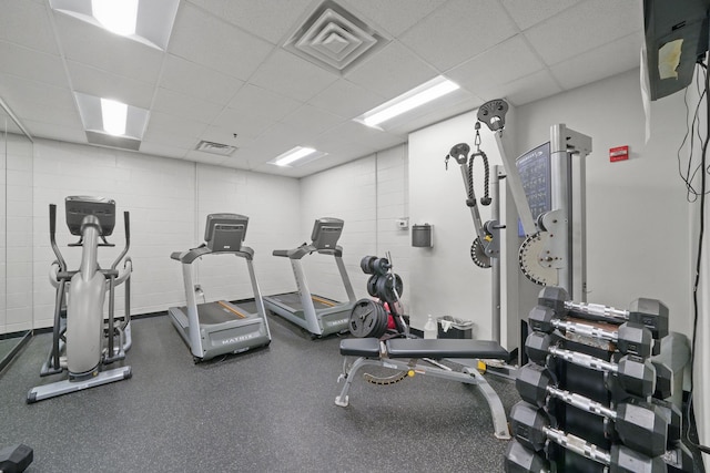 gym featuring visible vents and a paneled ceiling