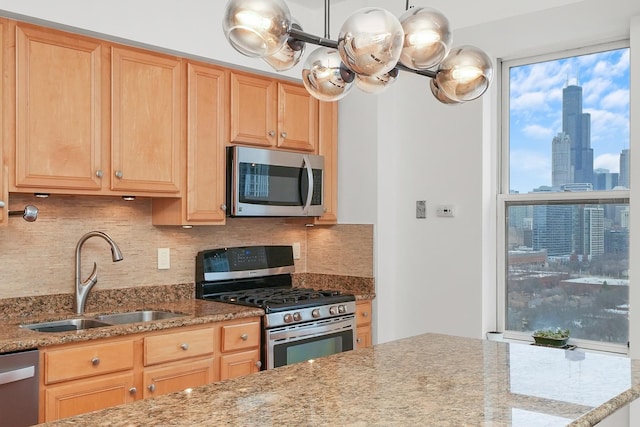 kitchen featuring a view of city, light brown cabinets, appliances with stainless steel finishes, and a sink