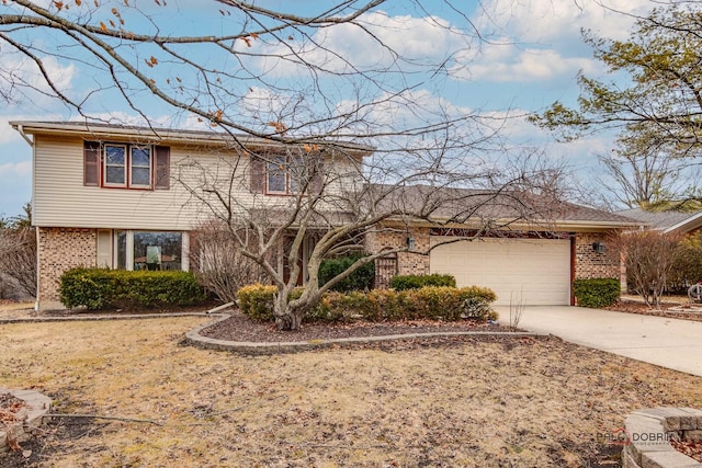 traditional-style home featuring driveway, an attached garage, and brick siding