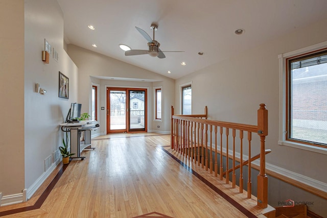 entrance foyer featuring lofted ceiling, baseboards, wood finished floors, and recessed lighting